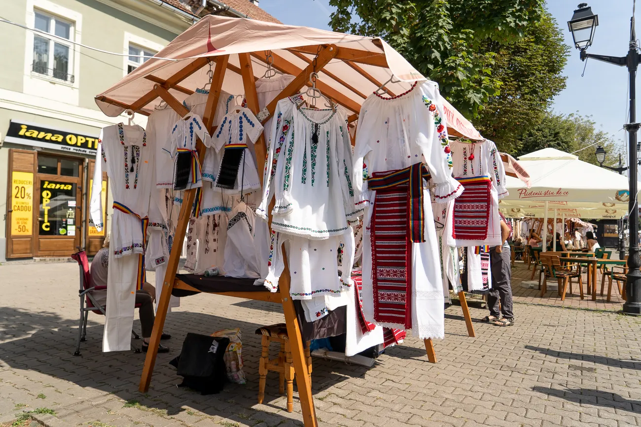 Traditionelle weiße Kleidung mit bunten Stickereien an einem Marktstand